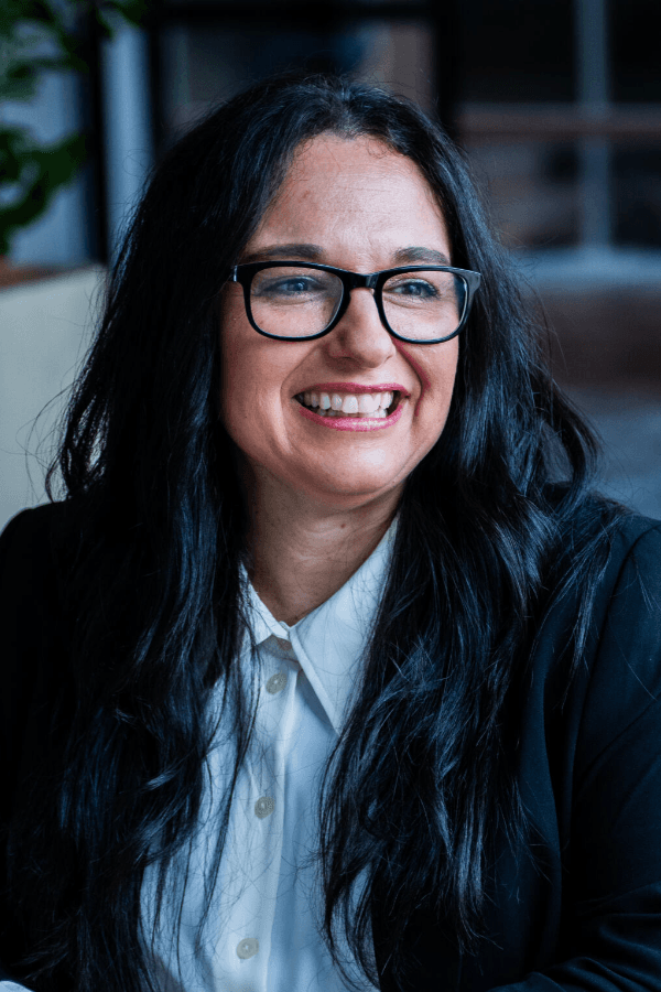 Team member smiling in a professional setting