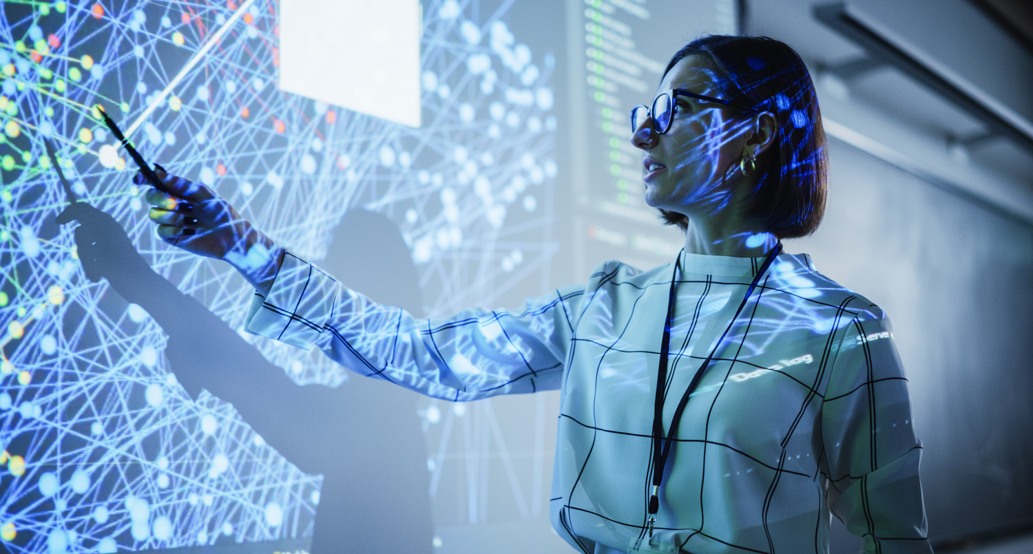 Professional pointing at a large neural network data visualization display